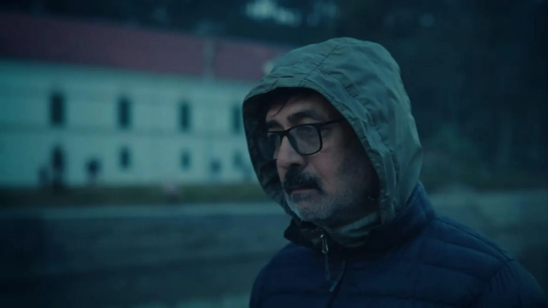 A man in a hooded jacket and glasses on a cold evening, from Samaya ko Cycle